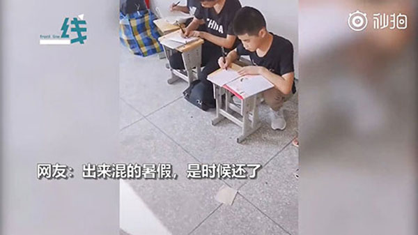 学生暑假作业不合格趴教室外面狂补